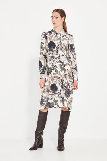 Woman wearing a floral dress with long sleeves by Verge on a white background