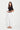 Woman wearing a black top and the white Paris Jean by Verge on a white background