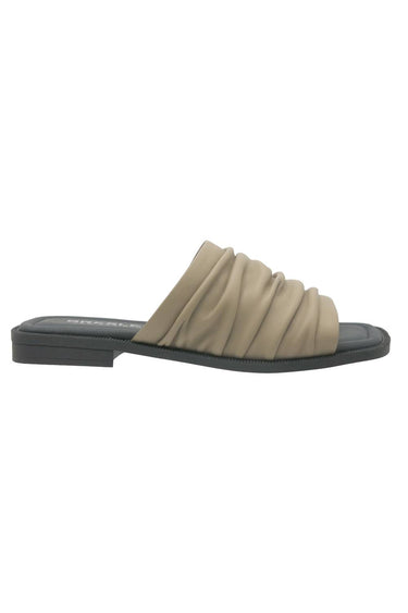 A single Dark Stone slide sandal with a ruched strap and a low black heel, shown from a side profile on a white background. A Verge selection.