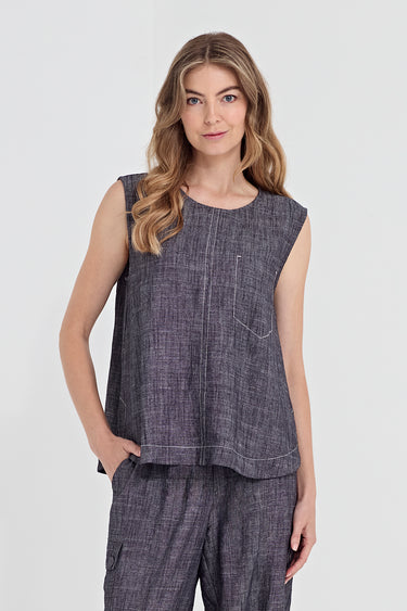 A woman modeling a sleeveless dark gray textured top and matching pants by Verge against a light gray studio background.
