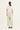Woman wearing a white top and Putty Homeland Pants by Verge on a white background