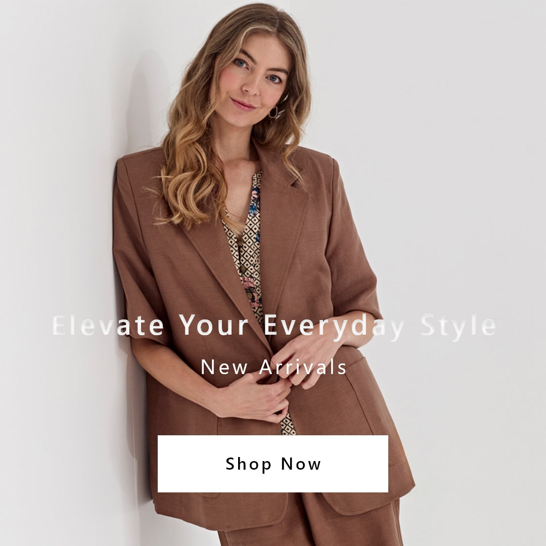 A woman wearing a brown tailored blazer by Verge over a patterned top, leaning against a light gray wall. White text overlays read 'Elevate Your Everyday Style', 'New Arrivals', and there is a 'Shop Now' button at the bottom.