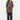 Woman wearing a brown coat, striped shirt, and black pants by Verge on a white background